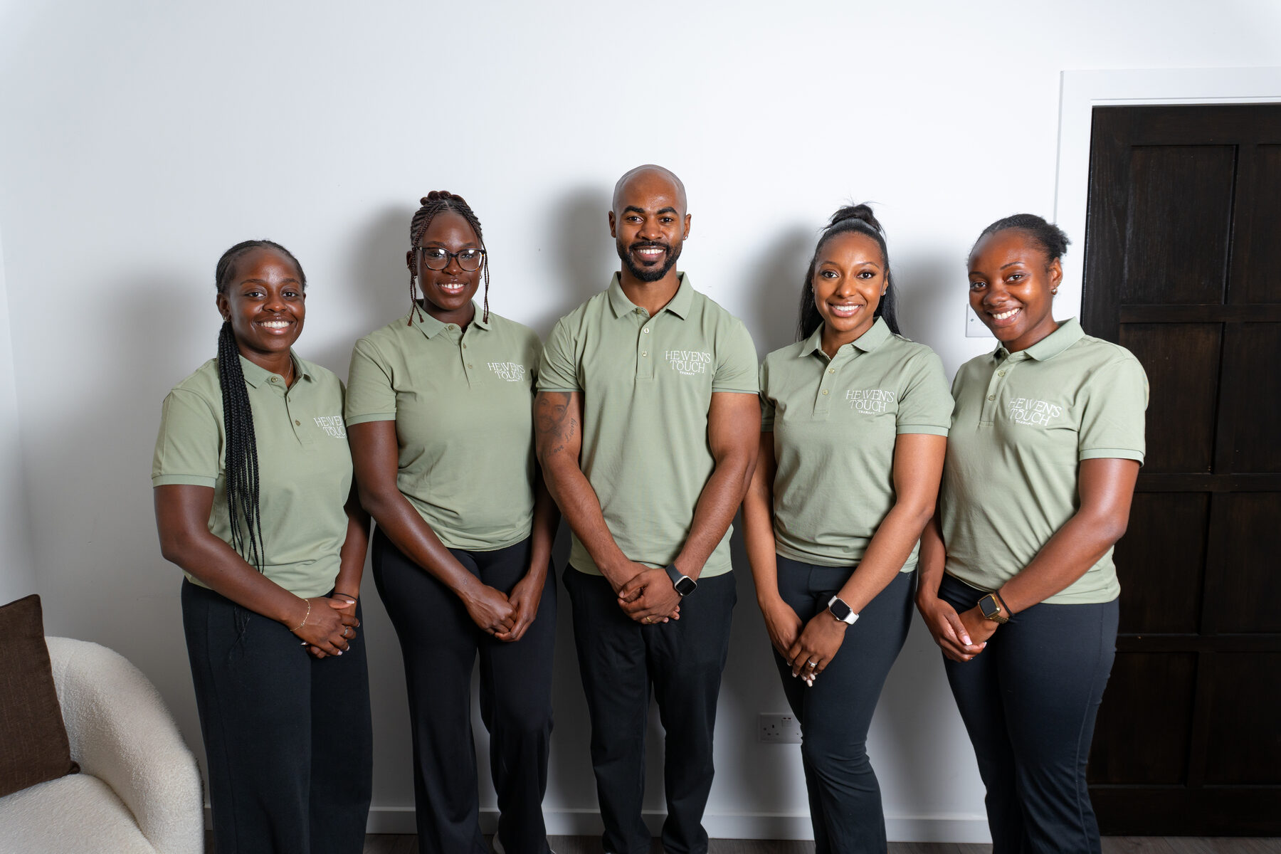 The Heaven's Touch Therapy team, together at the clinic in matching sage polos